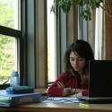 MSU student with laptop studies in the MSU Union